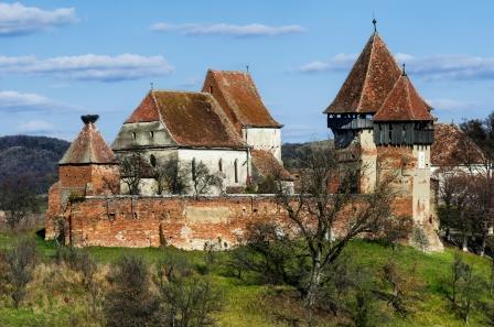 Tower and walls of fortified church Alma Vii, Transylvania. Romania