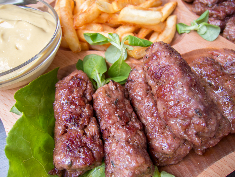 romanian traditional food meat rolls mici with fries and mustard